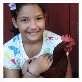 girl holding chicken